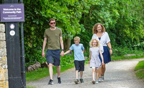 A family walking along the Community Path between Blenheim Palace and Hanborough train station