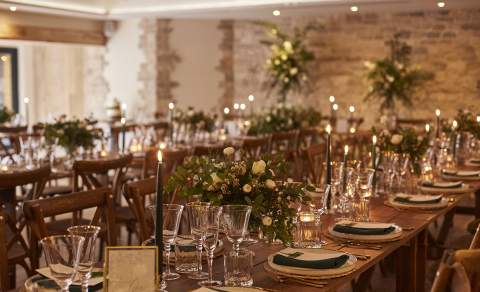 Sparkling glasses and white flower arrangements on wooden tables