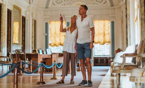 A couple exploring one of the grand rooms at Sledmere House in East Yorkshire