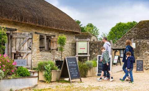 A family walking to Cogges Manor Farm in Witney