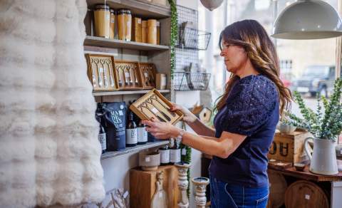 A woman looks at a gift in No.31 Burford
