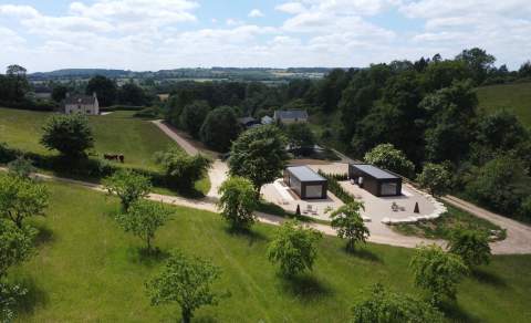 The trendy cabins, which are made from high-end eco materials, sit amongst trees and rolling fields at Boyd Farm Bantam Houses in the Cotswolds