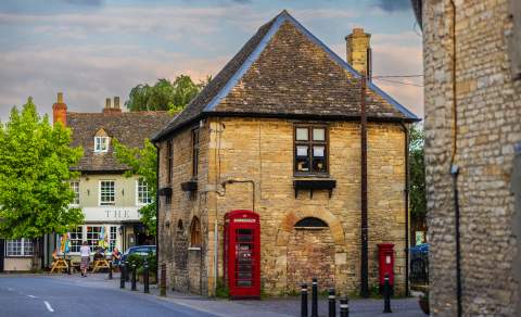 The centre of Eynsham with traditional red telephone box and Cotswold stone buildings
