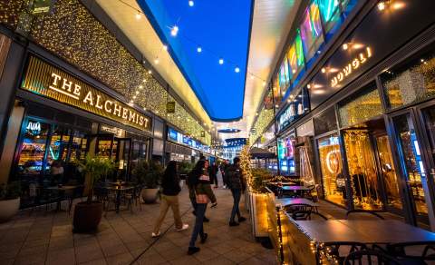 Visitors walking through The Brewery Quarter in Cheltenham