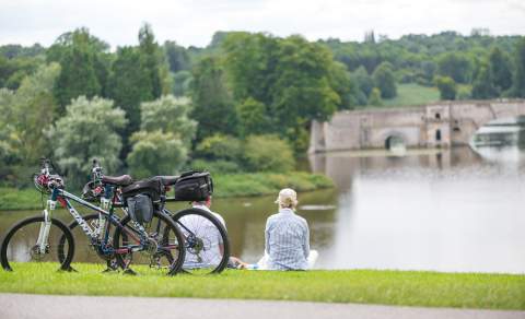 A couple take a break from their cycle route and enjoy lake view at Blenheim Palace