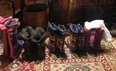 Line of wellie boots in front of fire at Waterloo Arms pub in Lyndhurst in the New Forest - Pub walks insp