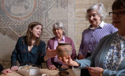 An expert tour guide talks to a group about artefacts at the Corinium Museum
