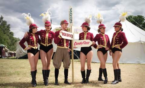 Circus staff with feathers on their heads