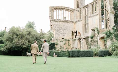 Two grooms walk through the grounds of Sudeley Castle