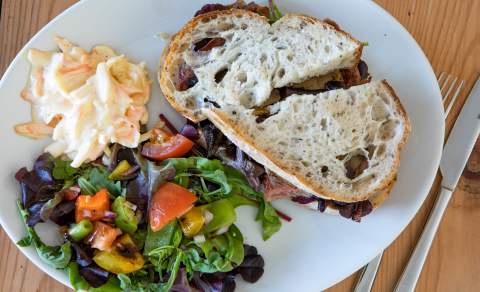 A sourdough sandwich with colourful salad and coleslaw at Cotswold Outpost in the Cotswolds