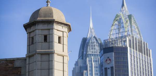 Spire of Colonial Fort Condé with sky scrapers in the background in Mobile, AL