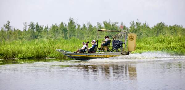 People riding in an airboat in the Mobile Bay