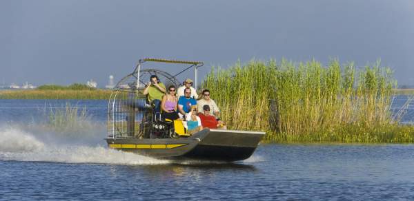 group of people riding on an airboat