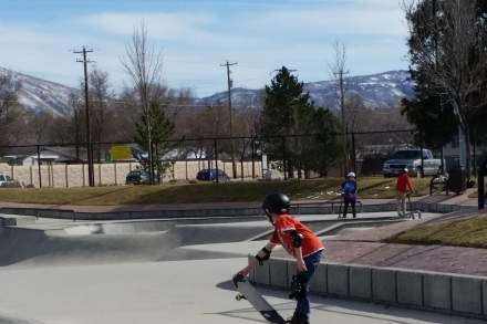 A child is skating at Lone Peak Skate Park at Lone Peak Park