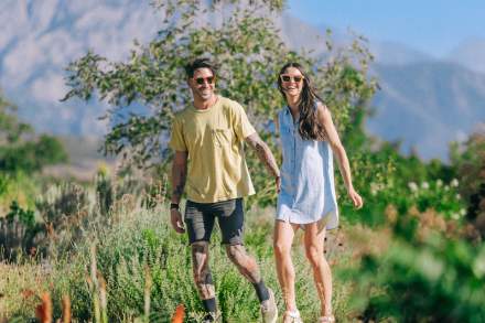 A woman and man hold hands through Red Butte Garden.