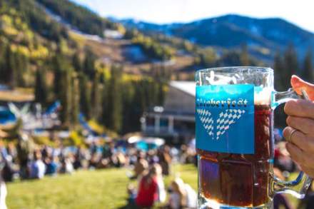 A person holding up a stein at Oktoberfest at Snowbird.
