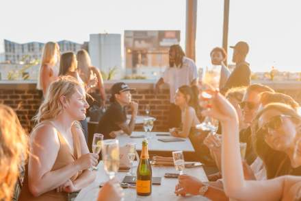 People drinking at Sunday School's rooftop bar.