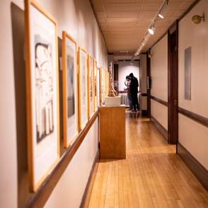 hallway in an art museum with hanging pictures