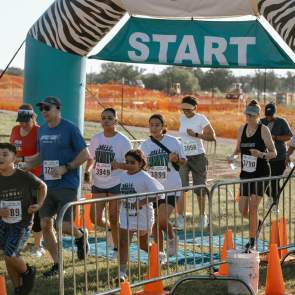 Start of the Unity Fun Run with runners taking off to participate.