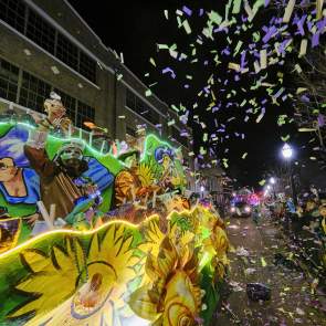 Mardi Gras float with confetti and crowd of people