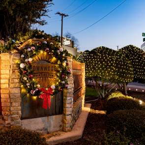 Photo of the Downtown Entry way on Center avenue featuring a Christmas Wreath and other christmas lights on display for the Holiday season.