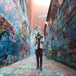 Father with son on shoulders in Graffiti Alley
