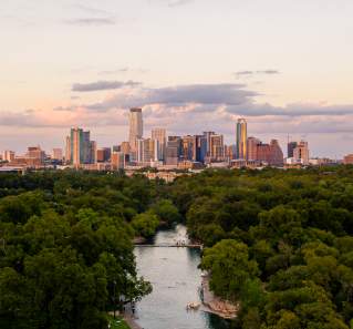 Aerial view of Barton Springs Pool and downtown Austin Texas skyline