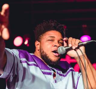 Kalu and The Electric Joint singing on stage in austin texas