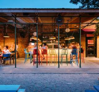 People dining at the colorful bar at Home Slice in Austin Texas