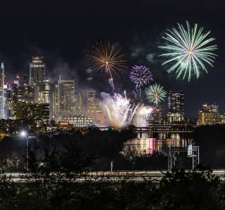 Fireworks over the downtown Austin skyline at night
