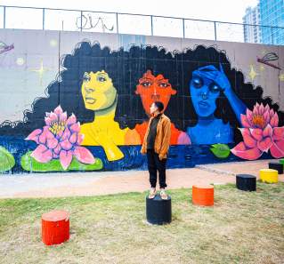 Artist Sade Lawson in front of her mural Its Okay to Not Be Okay