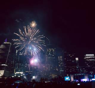 Fireworks shining over the downtown skyline.