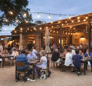 people dining in the beer garden at Contigo in east austin texas