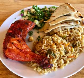 platter of chicken and sides with an international flair