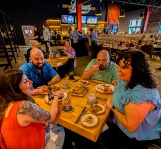 group of people enjoying food in a restaurant