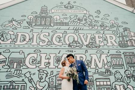 Wedding Couple in front of Discover Charm mural