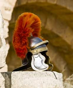 A centurion helmet displayed on roman ruins