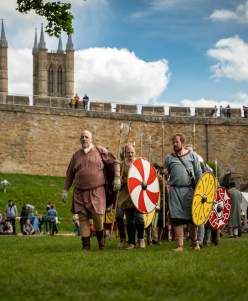 A group of people re-enacting historic battles and life