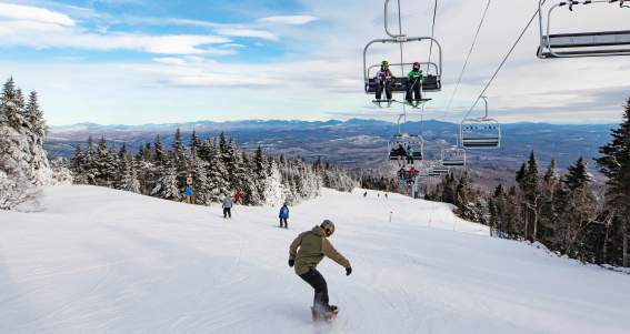 Adult Man Snowboarding Down a Ski Trail