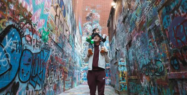 Father with son on shoulders in Graffiti Alley