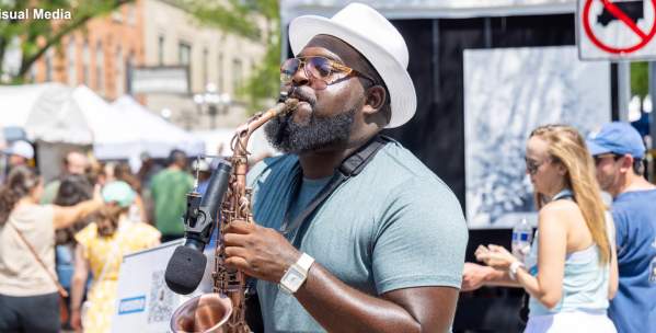 Main playing the saxophone at the Art Fair