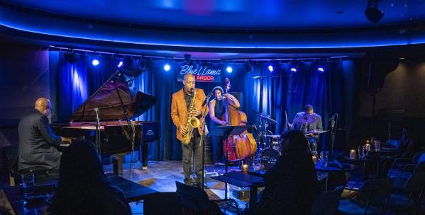Band on stage, Man playing saxophone, woman on standup bass