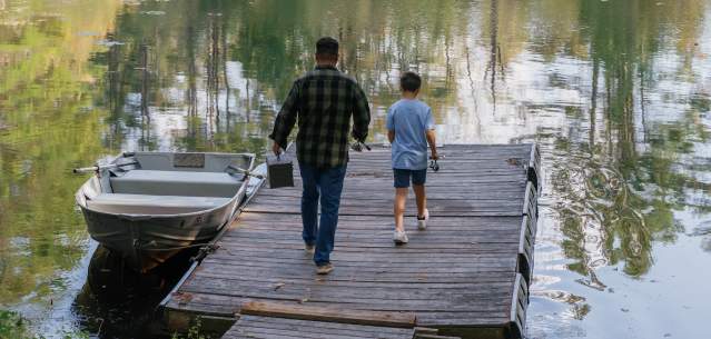 Father and son fishing at Hide-A-Way Waterfront Cottages