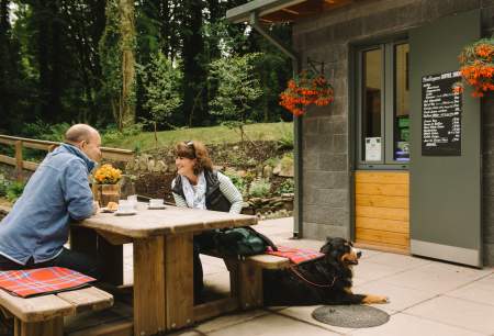 Couple enjoying coffee with pet dog