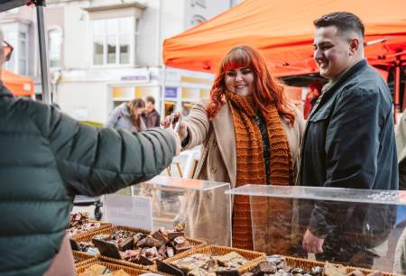 Couple trying food at a street food festival