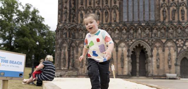 Lichfield Cathedral Family Days Out boy enjoys The Beach installation