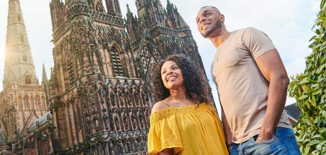 Couple outside Lichfield Cathedral on a sunny day