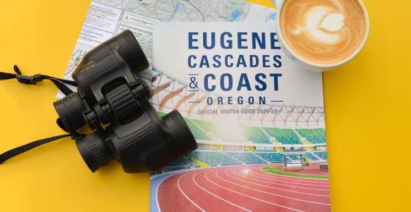 Eugene cover visitor guide with binoculars and coffee
