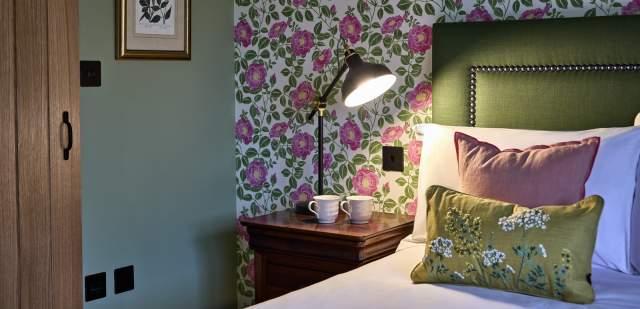 Floral themed hotel room with green accented headboard, Black Horse Climping