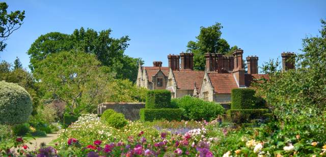 Pretty flower beds and manor house at Borde Hill Garden, Sussex